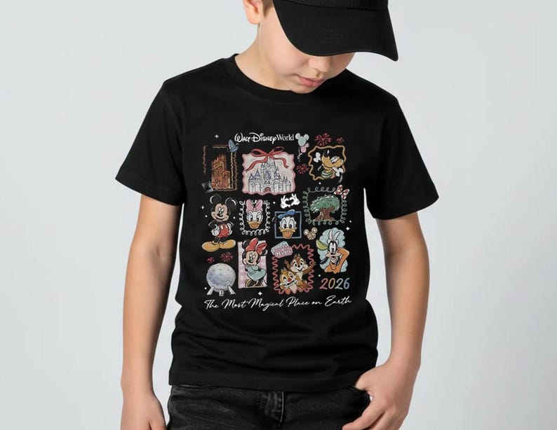 May include: Black t-shirt featuring a colorful collage of Disney characters and landmarks. The design includes Mickey Mouse, Minnie Mouse, Donald Duck, and Chip and Dale, with the text "Walt Disney World" and "2026 The Most Magical Place on Earth."