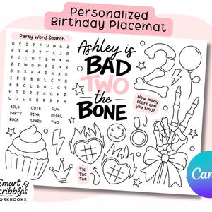 May include: Personalized birthday placemat with a black and white design. Features a word search, the phrase "Ashley is BAD TWO the BONE", and various illustrations like a cupcake, skeleton hand, and stars.