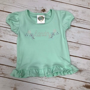 Sweet Sketch Wand design on Mint ruffled tee!