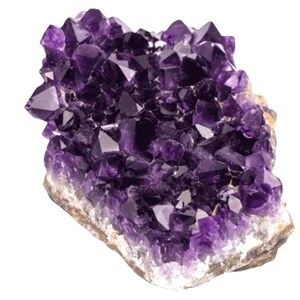 May include: A cluster of amethyst crystals, showcasing a deep purple hue with a crystalline structure. The crystals are densely packed, creating a textured surface. The base of the cluster has a rough, beige appearance, contrasting with the vibrant purple.