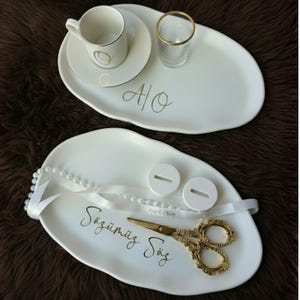 May include: A set of three ceramic nesting bowls in shades of blue, green, and white. The bowls feature a speckled glaze and a simple, modern design. The largest bowl measures approximately 6 inches in diameter.