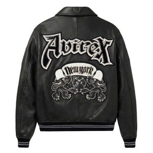 May include: A black leather jacket featuring a large embroidered Avirex logo across the back in white and black. Below the logo is a banner with the text New York and an emblem of two lions facing each other. The jacket has a ribbed collar and cuffs.