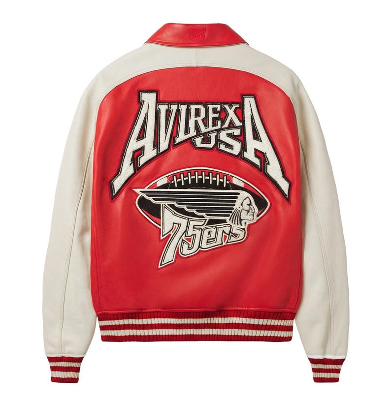 May include: A red and off-white varsity jacket featuring a large embroidered patch on the back. The patch displays the text AVIREX USA above a football graphic with a winged profile and the word 75ers. The jacket has a red collar and striped cuffs.