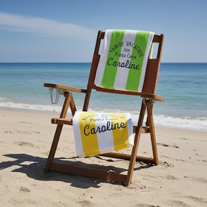 May include: A wooden beach chair with two personalized striped beach towels. One towel is green and white, the other is yellow and white. Both towels have the text "Family Vacation 2026 Punta Cana Caroline". The chair is on a sandy beach.