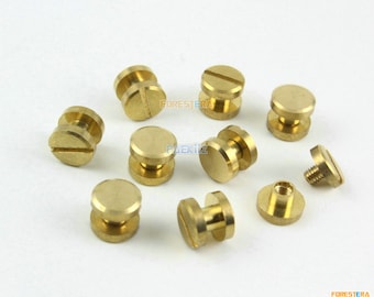 May include: A collection of ten brass screw-in standoffs, also known as spacers, with a flat top and a threaded bottom. The standoffs are arranged in a random pattern on a white surface.