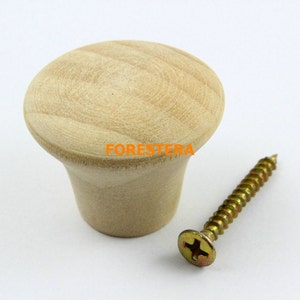 May include: A light wood knob with a screw. The knob is round and has a smooth surface. The screw is gold and has a Phillips head.