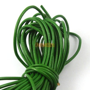 May include: A close-up of a spool of bright green leather cord. The cord is tightly wound and appears to be made of high-quality leather.