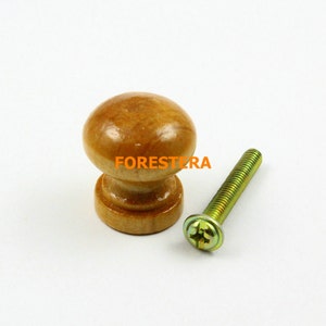 May include: A wooden knob with a natural finish and a brass screw. The knob is round and has a smooth surface. The screw is a standard size and has a Phillips head.
