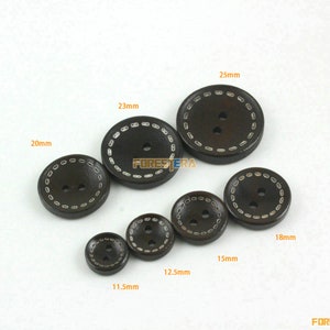May include: Assortment of brown wooden buttons with white stitching around the edges. The buttons are in various sizes, ranging from 11.5 mm to 25 mm in diameter.