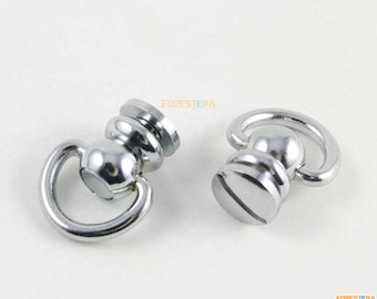 May include: Two silver metal swivel snap hooks with a round base and a screw-on top. The hooks are designed for attaching to a strap or other item.
