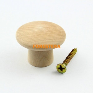 May include: A wooden mushroom-shaped knob with a screw. The knob is light brown and has a smooth surface. The screw is gold-colored and has a Phillips head.