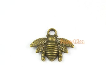 May include: A bronze bee charm with a textured body and wings. The charm has a loop at the top for attaching to a necklace or bracelet.