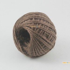 May include: A ball of brown twine, a natural fiber rope, perfect for crafting and DIY projects.