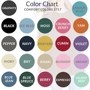 May include: Color chart of Comfort Colors 1717, featuring a variety of colors in circular swatches. Colors include Graphite, Black, Ice Blue, Moss, Crunch Berry, Yam, Pepper, Navy, Mustard, Cumin, Violet, Ivory, Bay, Khaki, Blossom, Orchid, Blue Jean, Blue Spruce, Berry, Espresso, and Island Reef.