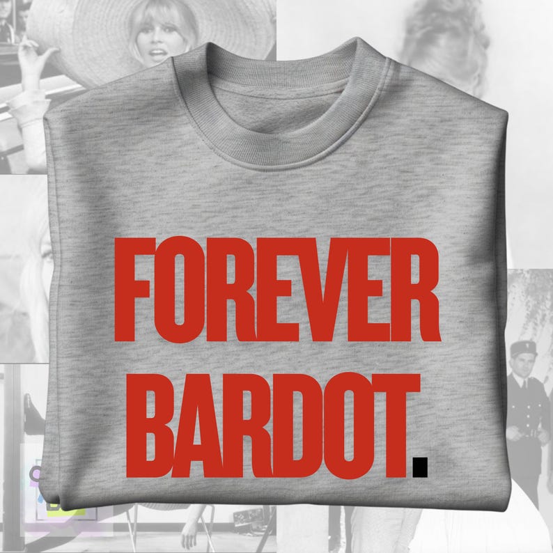 May include: A light gray sweatshirt with the words "FOREVER BARDOT" in large, red capital letters. The sweatshirt has a crew neck and long sleeves. The background features black and white images.