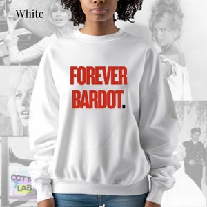 May include: White sweatshirt with the red text "FOREVER BARDOT." The long-sleeved top has a crew neck and a relaxed fit. The background features black and white images of a woman.
