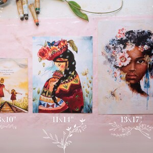 May include: Three different art prints with watercolor paintings. The first print is 8x10 inches and features two people walking on a train track. The second print is 11x14 inches and features a woman with a flower crown holding a child. The third print is 13x17 inches and features a woman with a flower crown and a colorful background.