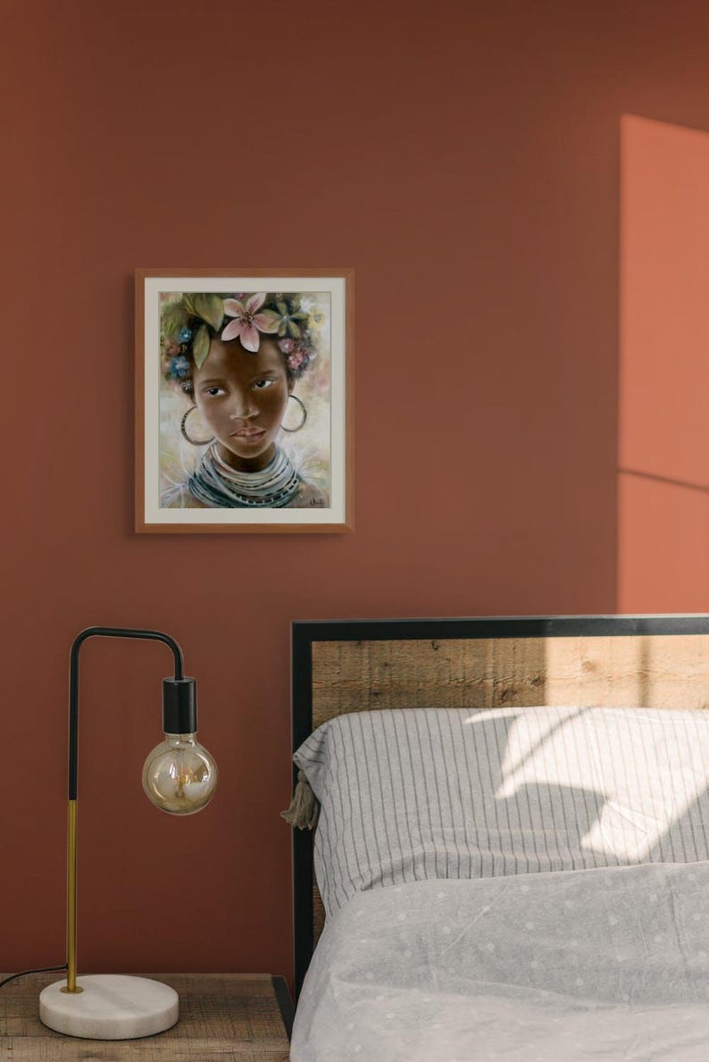 May include: A framed painting of a young woman with dark skin, wearing a floral crown and a necklace. She has large hoop earrings and is looking directly at the viewer.