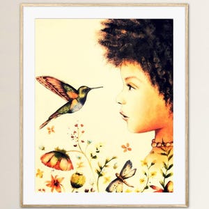 May include: A framed watercolour print depicting a young person observing a hummingbird in flight. The artwork features a vibrant hummingbird with colourful wings, set against a backdrop of flowers and a soft, yellow background. The print is in a wooden frame.
