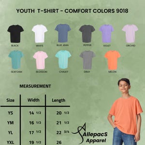 May include: A white ceramic mug with a black handle and the text "But First, Coffee" in a bold, black font. The mug is set against a blurred background. The mug appears to be approximately 10 cm tall.