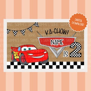 May include: A digital download birthday card featuring a red cartoon race car with the text "Ka-Chow!" and "Name is 2". The card includes a checkered flag border and a banner of checkered flags.