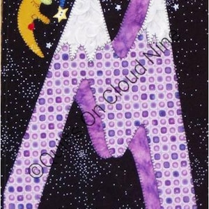 May include: A fabric wall hanging featuring a large letter M appliqued with purple grid and solid purple fabric against a black background with white stars. A yellow crescent moon wearing a blue nightcap is positioned to the left of the letter.