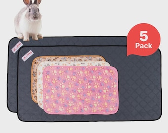 May include: A gray and white rabbit sits atop a stack of pet bed mats. The mats are in various colors and patterns, including a pink mat with paw prints. The image includes a red speech bubble that says "5 Pack".