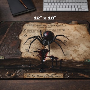 May include: A rectangular mouse mat, 30.48 cm x 45.72 cm, with a detailed illustration of a black spider with a red abdomen, dripping a dark liquid onto an open book. The text "FENENUM MORTIFERUM" and "The True Nature of Deadly Toxins" are visible.