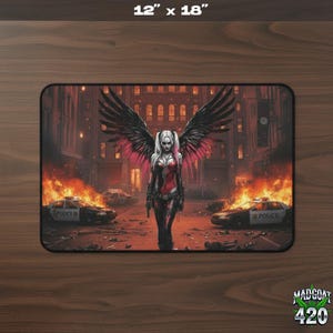 May include: A rectangular mousepad, 12 x 18 inches, featuring a digital illustration of a woman with angel wings in a post-apocalyptic scene. The woman is in a red and black outfit, with burning cars and buildings in the background.