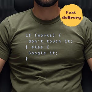May include: An olive green t-shirt with white text: "if (works) { don't touch it; } else { Google it; }". A yellow circle with "Fast delivery" is in the upper right. The shirt has a crew neck.