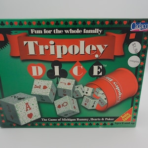 May include: A Tripoley Dice game box with a green background and red accents. The box features the game's name, dice, and a red dice cup. The text "Fun for the whole family" is displayed at the top.