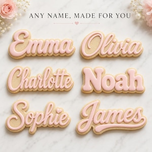 May include: Six custom-made biscuits with light pink icing lettering on a tan base. The names Emma, Olivia, Charlotte, Noah, Sophie, and James are written in various script and block fonts. The text ANY NAME, MADE FOR YOU is centred above.