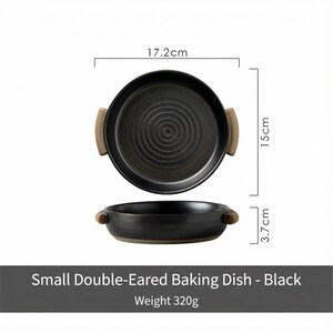 May include: Black double-eared baking dish with a textured interior and wooden handles. The dish is 17.2 cm in diameter, 15 cm long, and 3.7 cm high. The dish weighs 320g. The text on the image reads "Small Double-Eared Baking Dish - Black".