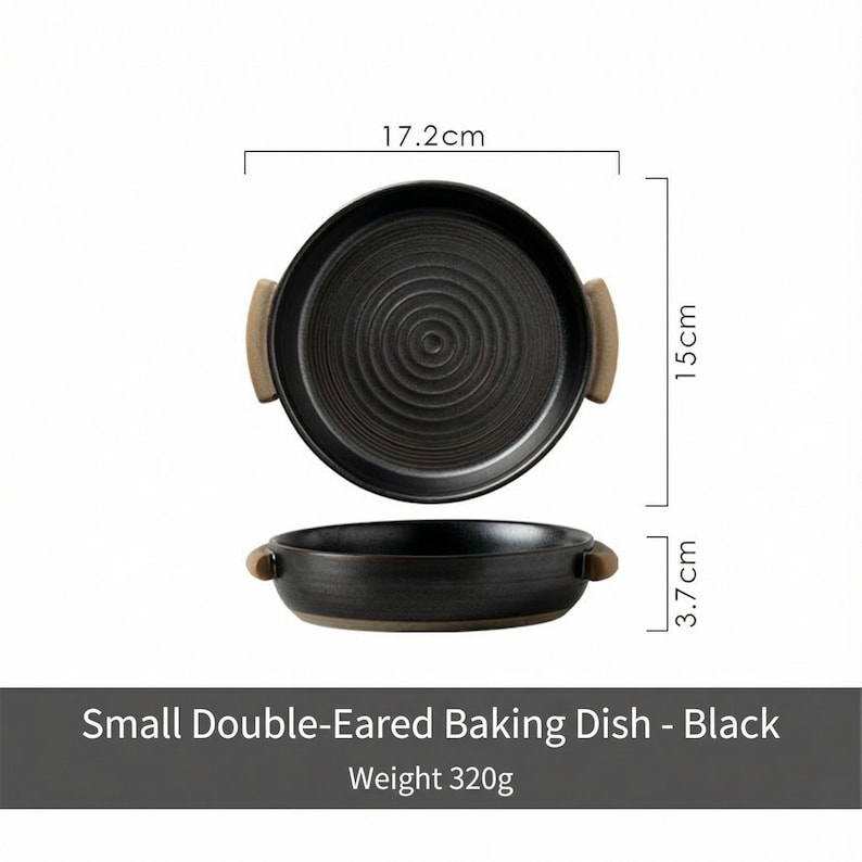 May include: Black double-eared baking dish with a textured interior and wooden handles. The dish is 17.2 cm in diameter, 15 cm long, and 3.7 cm high. The dish weighs 320g. The text on the image reads "Small Double-Eared Baking Dish - Black".
