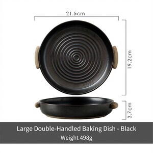 May include: Black, double-handled baking dish with a circular design. The dish is 21.5 cm in diameter and 19.2 cm wide, with a height of 3.7 cm. The handles are a light brown color. The text on the image reads: "Large Double-Handled Baking Dish - Black Weight 498g."
