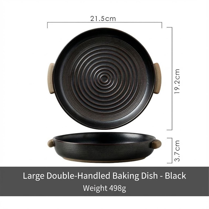 May include: Black, double-handled baking dish with a circular design. The dish is 21.5 cm in diameter and 19.2 cm wide, with a height of 3.7 cm. The handles are a light brown color. The text on the image reads: "Large Double-Handled Baking Dish - Black Weight 498g."