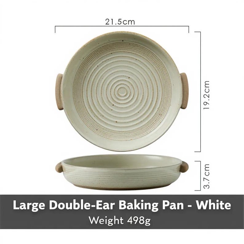 May include: White ceramic double-ear baking pan with a circular design. The pan is 21.5cm in diameter, 19.2cm wide, and 3.7cm high. The pan has two brown handles. The text on the image reads: Large Double-Ear Baking Pan - White, Weight 498g.