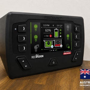 May include: A black Redarc RedVision display unit featuring a digital screen with battery status, light controls, and system icons. The device has physical buttons on the sides and bottom, with the Redarc logo and Australian flag emblem visible.