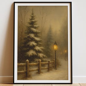 May include: Framed winter landscape art print. The artwork depicts a snow-covered path with a wooden fence, evergreen trees, and a glowing lamppost. The scene is set in a misty, muted color palette, evoking a serene, cold atmosphere.