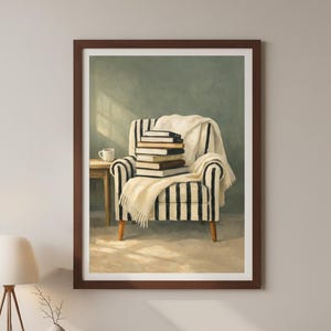 May include: A framed print of a cozy reading nook. The image features a striped armchair with a stack of books and a white blanket. A small table with a coffee cup sits nearby, creating a warm and inviting atmosphere.