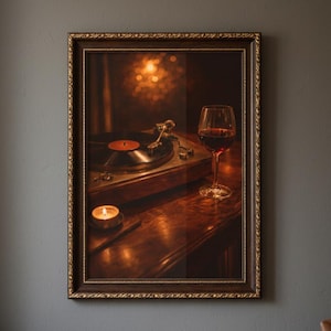 May include: A framed print depicting a vintage record player, a glass of red wine, and a lit candle. The print has a warm aesthetic with a dark wooden frame, evoking a sense of nostalgia.