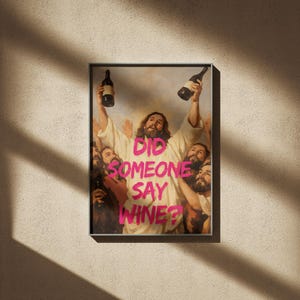 A framed funny altered art poster of Jesus holding two wine bottles with the neon pink text 'Did Someone Say Wine?', perfect for eclectic kitchen or home bar decor.