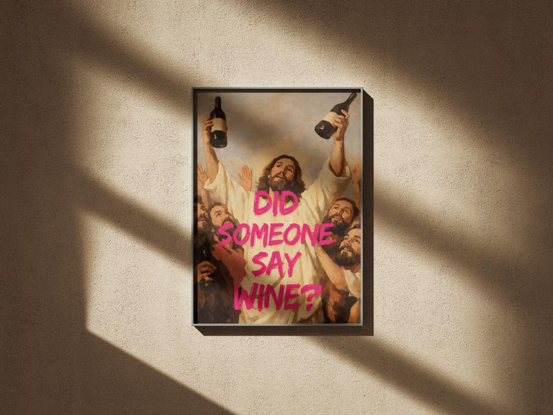 A framed funny altered art poster of Jesus holding two wine bottles with the neon pink text 'Did Someone Say Wine?', perfect for eclectic kitchen or home bar decor.