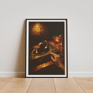 May include: Framed print of a record player with a vinyl record in place. A hand is positioned near the controls. A cocktail with an orange peel garnish is on the table. The image has a warm, inviting colour palette.