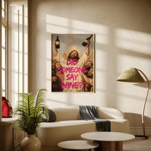 A framed funny altered art poster of Jesus holding two wine bottles with the neon pink text 'Did Someone Say Wine?', perfect for eclectic kitchen or home bar decor.