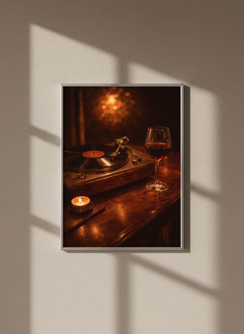 May include: Framed print showing a record player, a glass of red wine, and a lit candle on a wooden surface. The warm lighting creates a cosy atmosphere, suggesting a theme of music and relaxation.