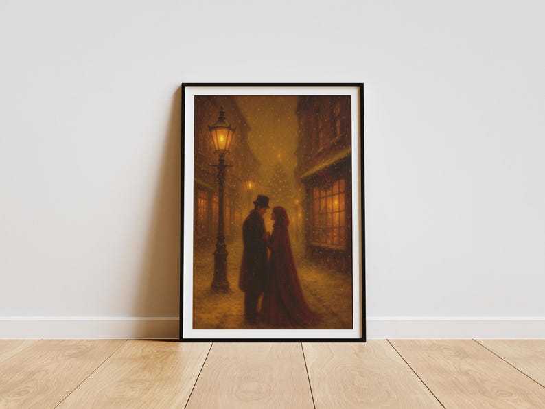 May include: A framed art print showing a couple in a snowy street, illuminated by a lamppost. The artwork features a man in a top hat and a woman in a red cloak. Buildings and a Christmas tree are visible in the background.