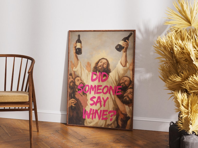 A framed funny altered art poster of Jesus holding two wine bottles with the neon pink text 'Did Someone Say Wine?', perfect for eclectic kitchen or home bar decor.