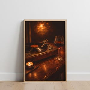 May include: A framed photograph shows a vintage record player with a vinyl record, a lit candle, and a glass of red wine. The scene is set on a dark wooden surface, creating a warm atmosphere. The image evokes nostalgia and relaxation, with a focus on music and leisure.