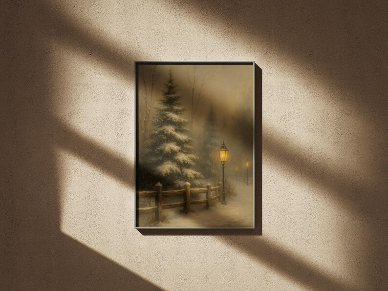 May include: Framed winter landscape art print. The artwork depicts a snow-covered path with a wooden fence, a lit lamppost, and a snow-covered evergreen tree. The scene is painted in muted tones, creating a serene and peaceful atmosphere.